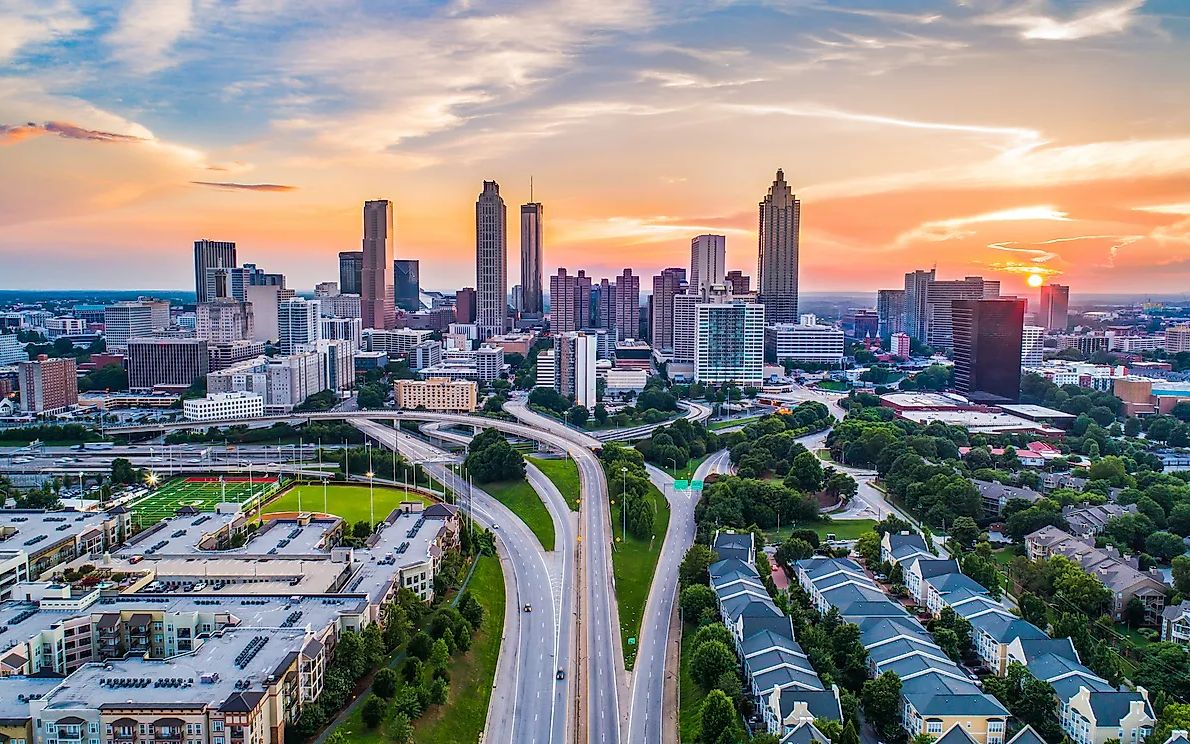 Atlanta skyline at sunset, with a highway leading into downtown